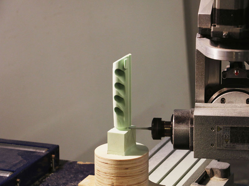 5 axis machine cnc cutting cutting out prototype for spear fishing band holder.