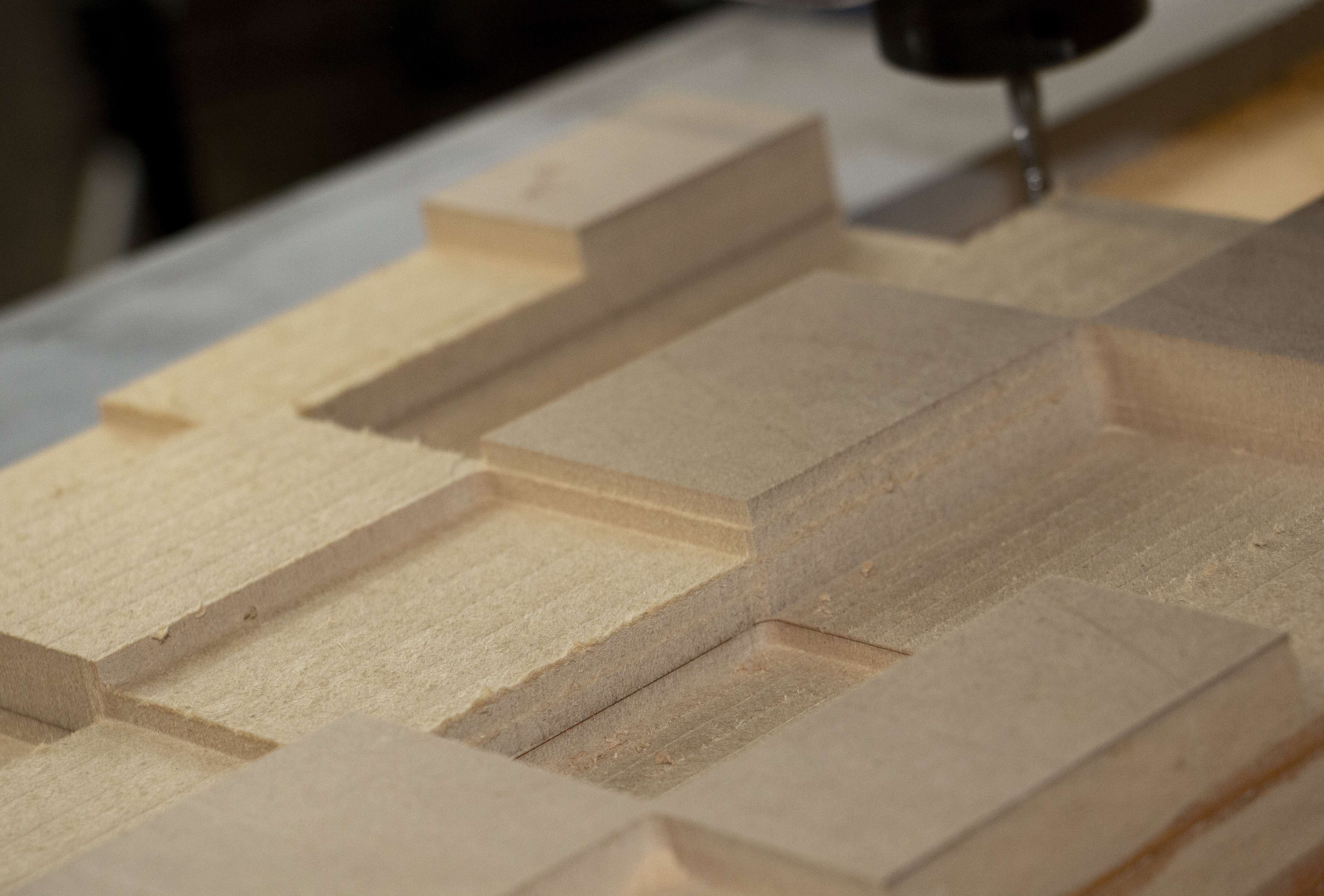 3 axis cnc machine cutting 3d squares into wooden block