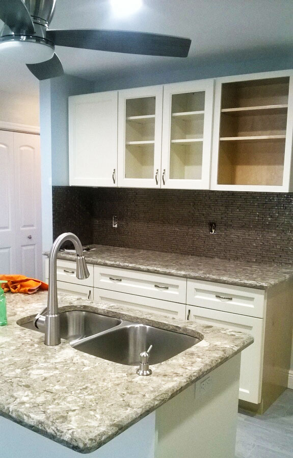 custom built kitchen with custom built cabinets and sink.