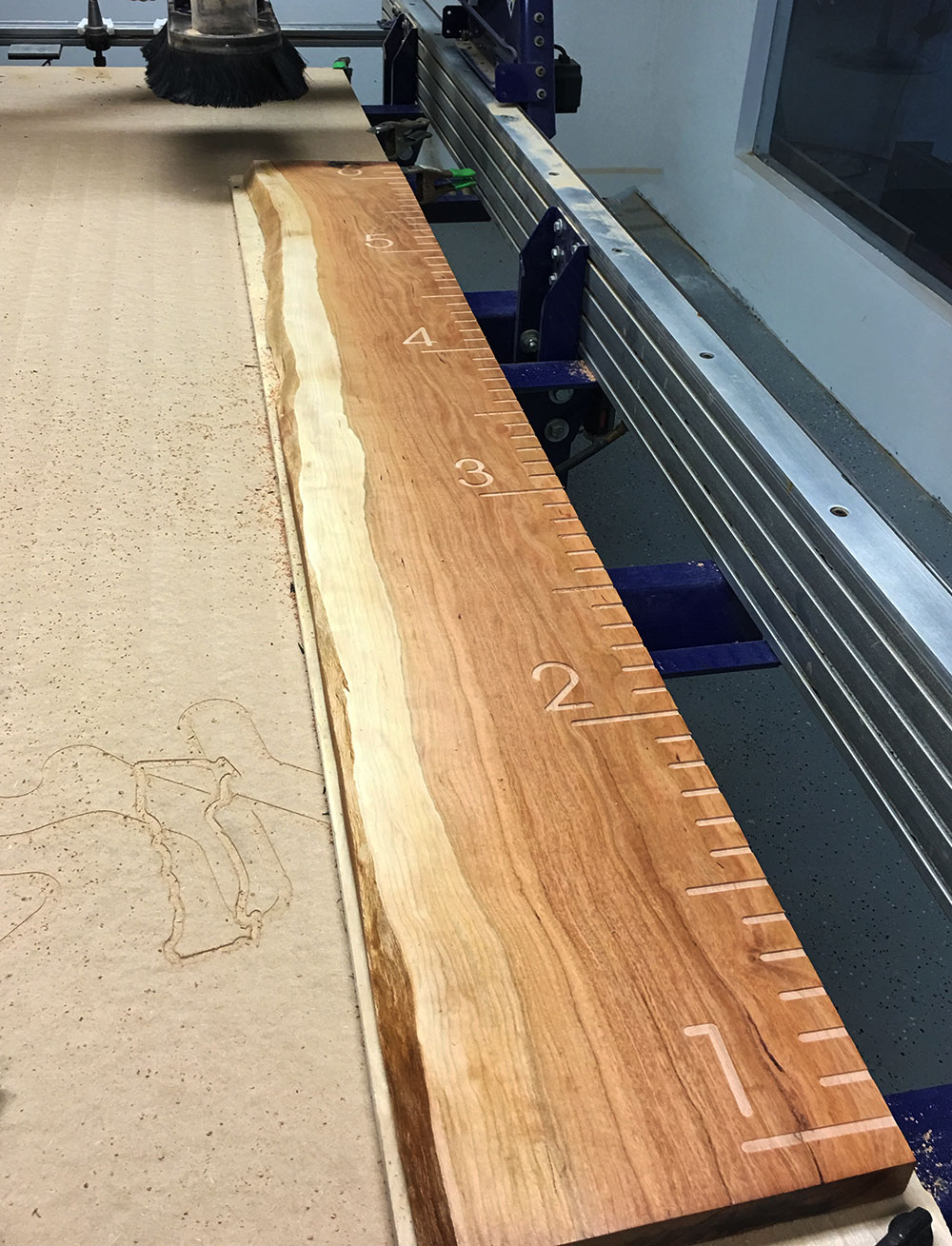 live edge wood growth chart reaching 6 feet laying on a cnc table.