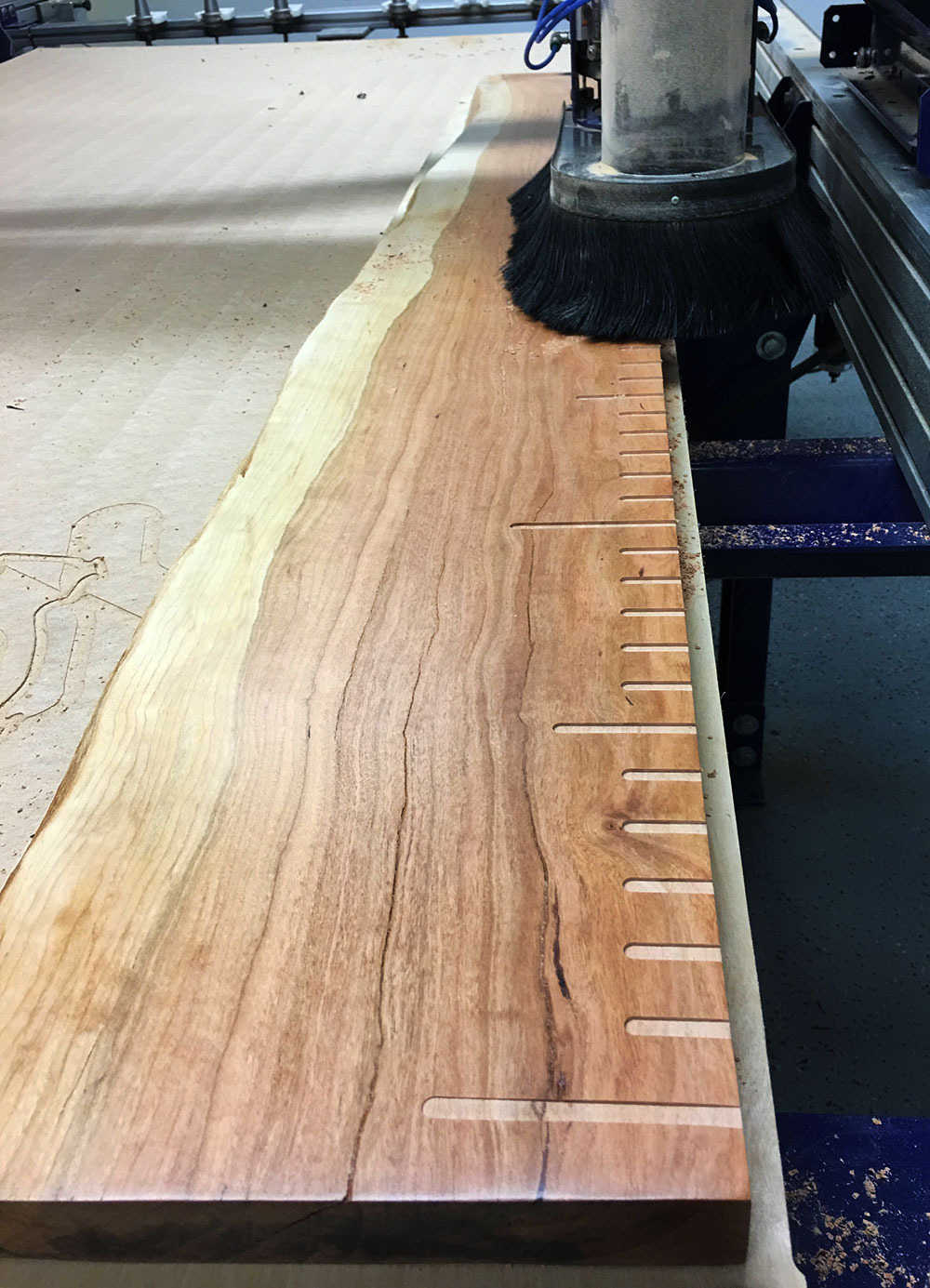 live edge wood having notches cnc cut along the side.