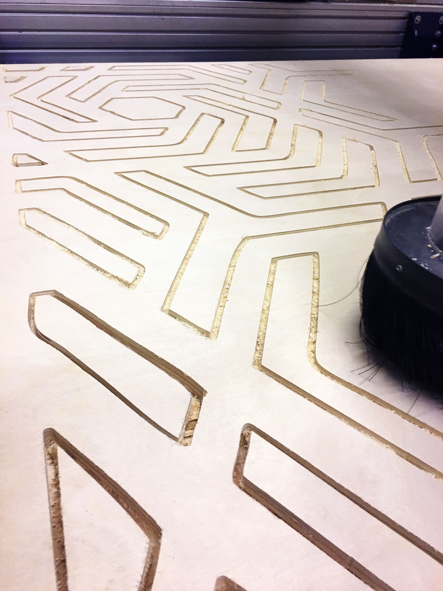 3 axis machine cutting custom shapes into wood panel
