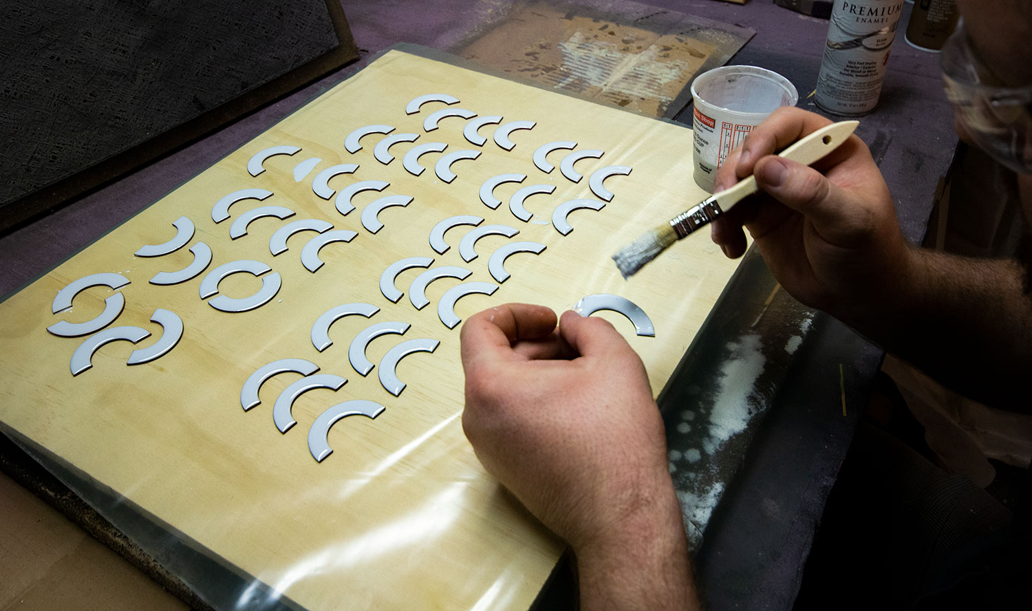 painting half moon wooden shapes white.