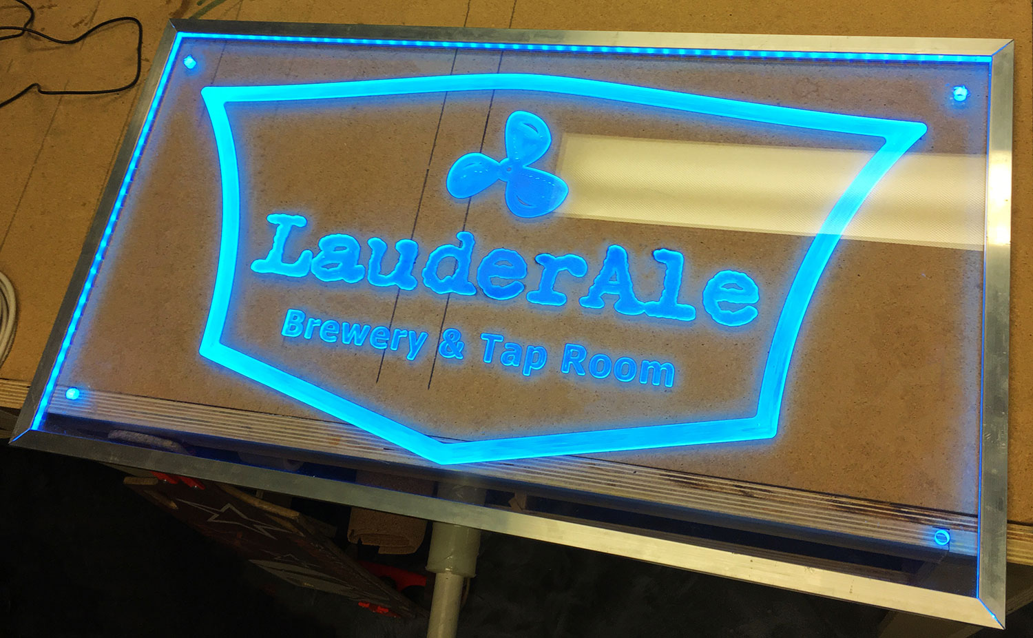 clear business sign lit up with blue LED lights.