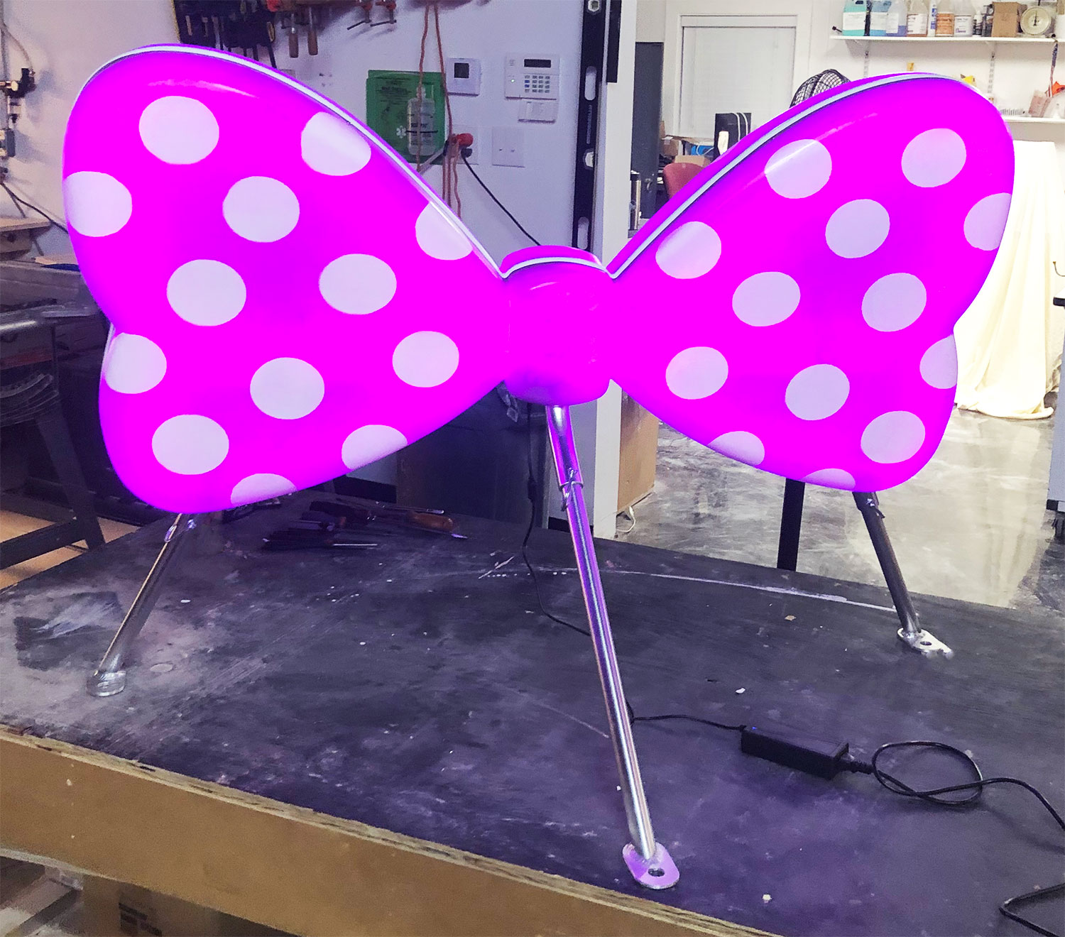 LED light pink fiberglass bowtie on a stand